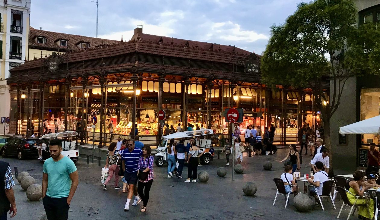 foodhallen in centrum Madrid in de avond met een plein ervoor met voetgangers